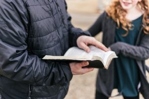 Transformative Bible Studies for Families: Building Faith Together - photo of dad holding Bible with daughter